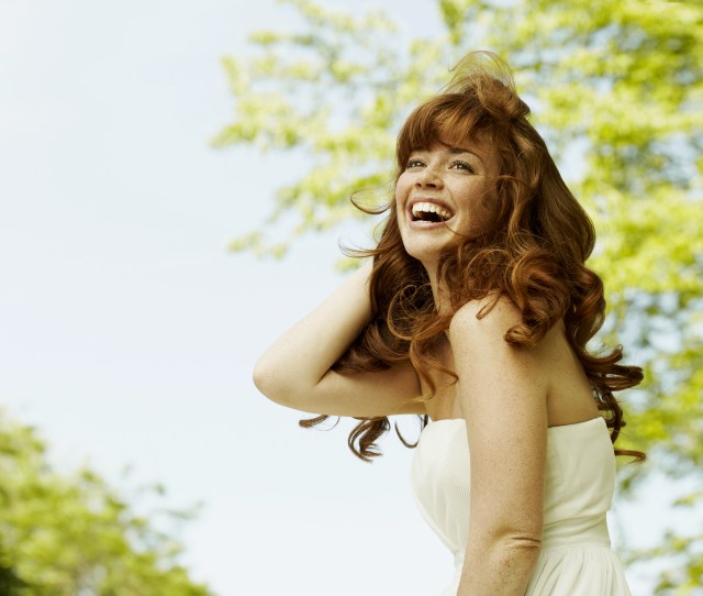 Young woman with long hair, laughing